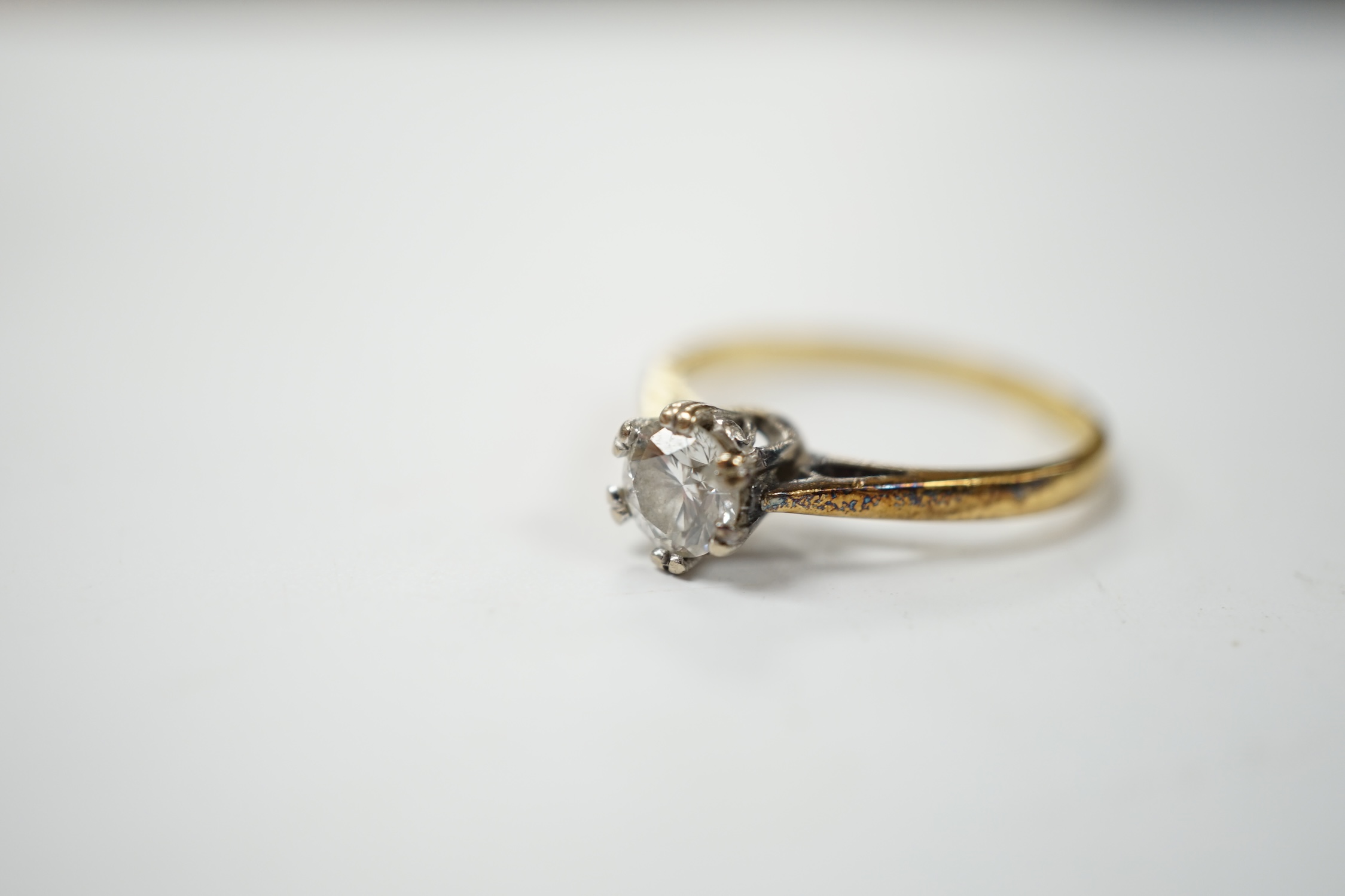 A modern 18ct gold and solitaire diamond set ring, size N, gross weight 2.8 grams. Condition - fair